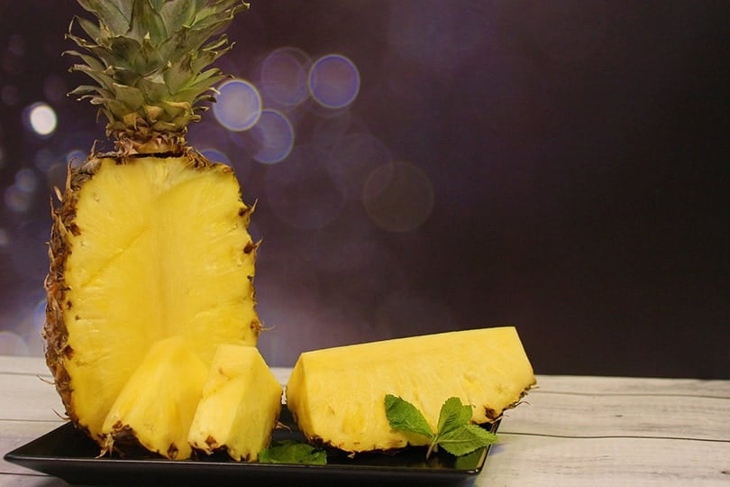 sliced pineapple on black tray