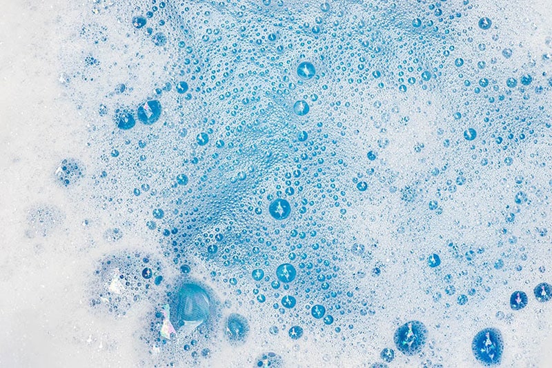 soapy water in a blue basin