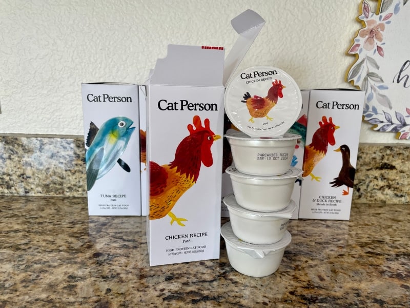 stack of cat person food containers