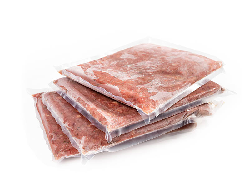 stack of frozen pet food on vacuum bags