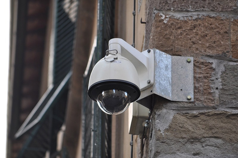 surveillance camera on a brick wall