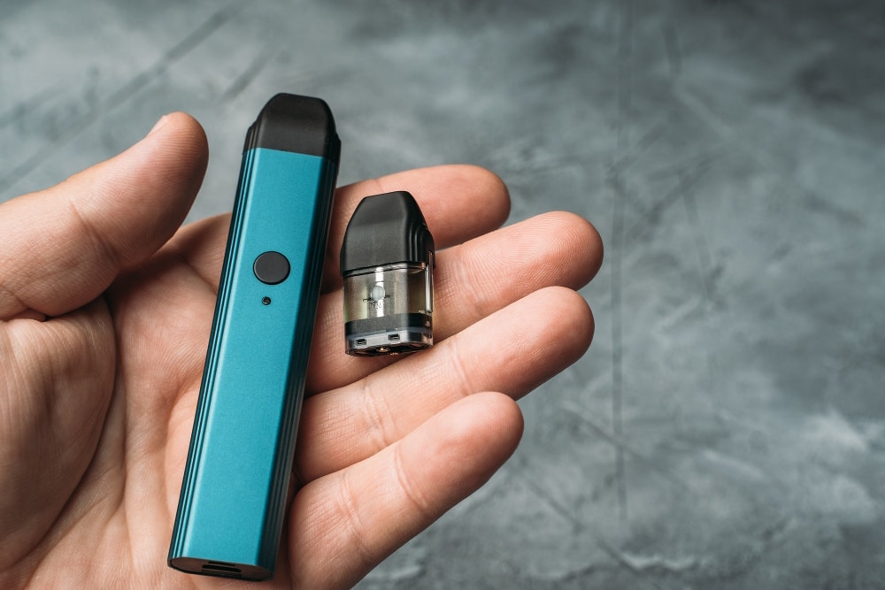 vape device in mans hand