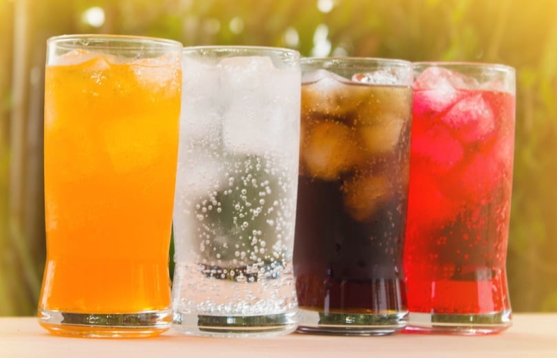 variety of soda in glasses