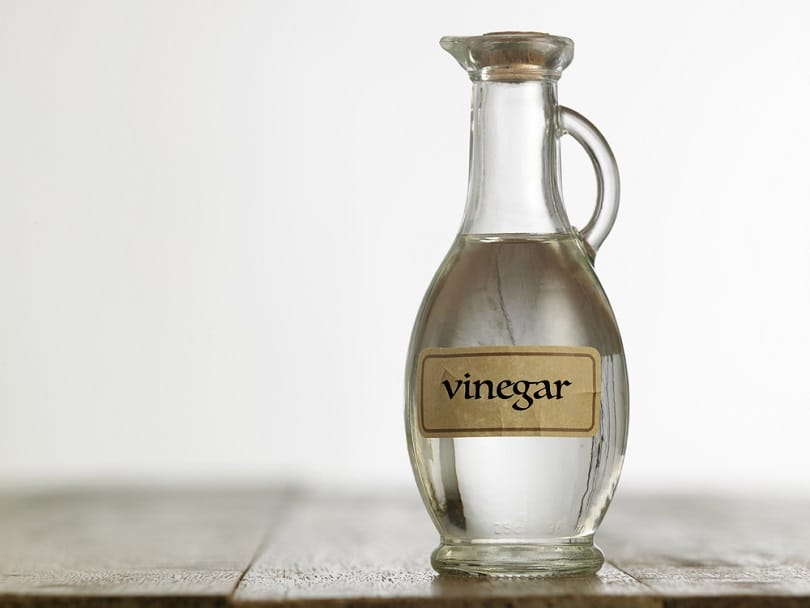 white vinegar on the wooden table top