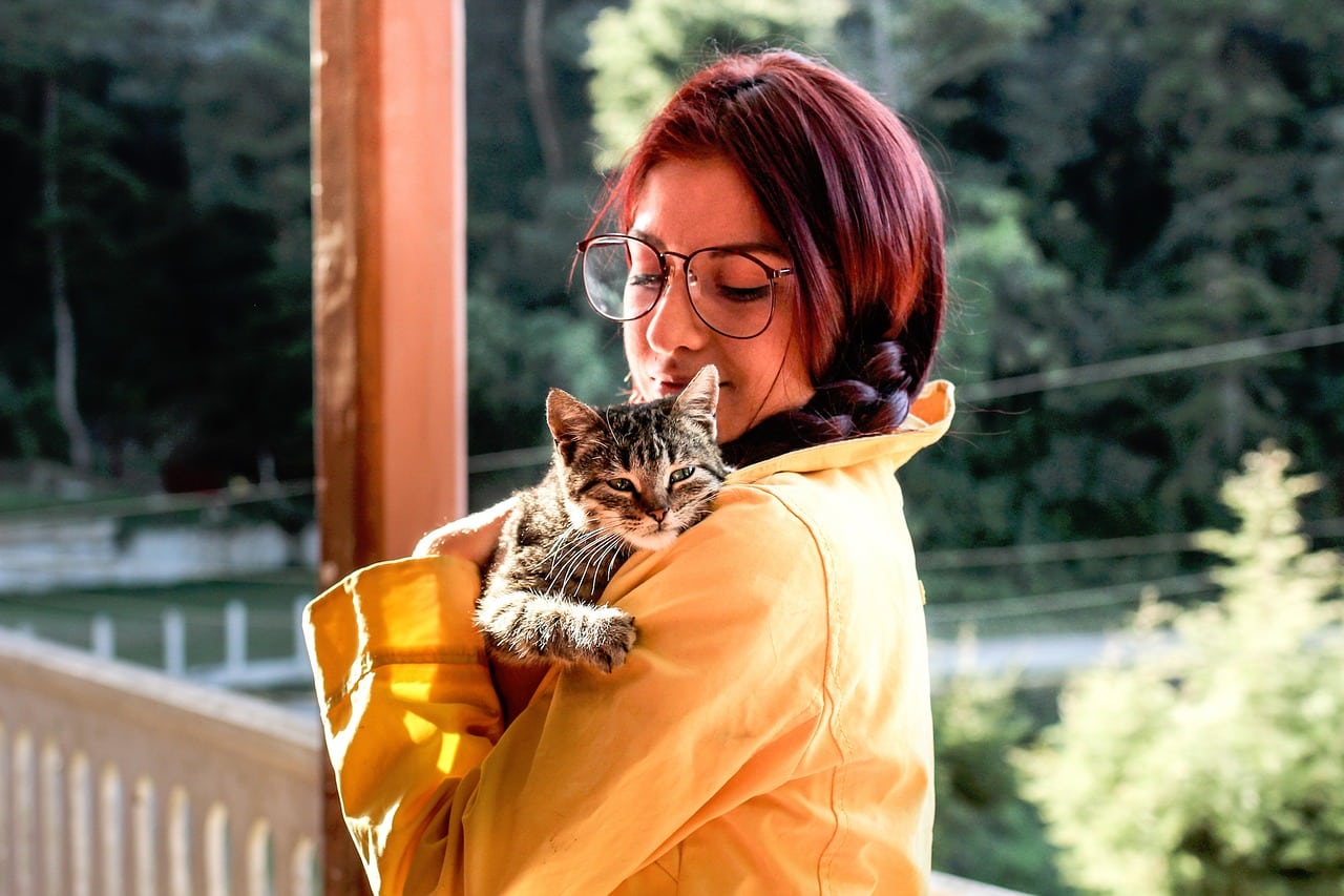 woman carrying a cat