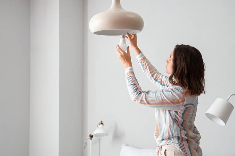 woman changing bulb