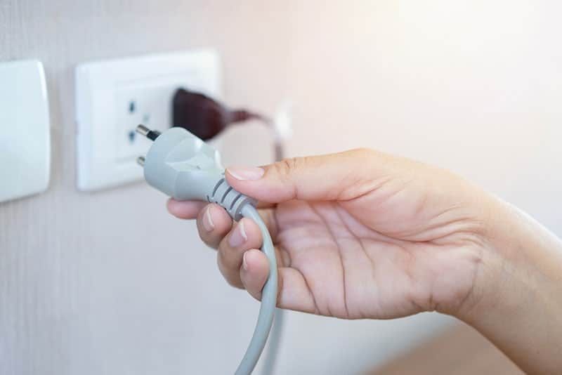 woman holding a power cord