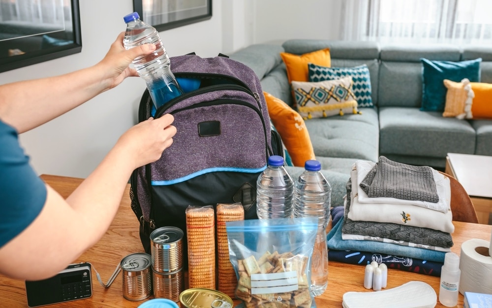 woman preparing emergency backpack