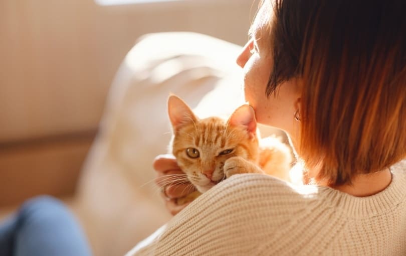 woman resting with her cat