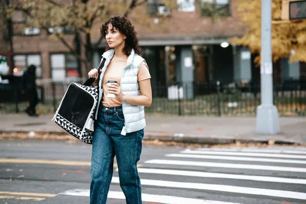 woman with pet carrier and coffee