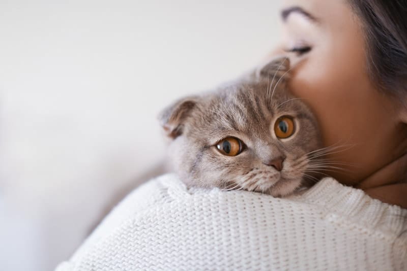 young woman hugging her cat