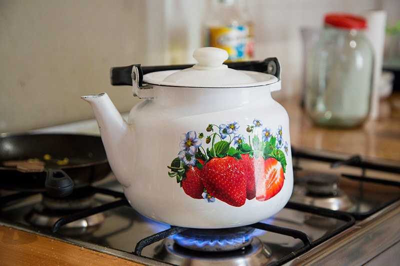 boiling water using a ceramic tea pot