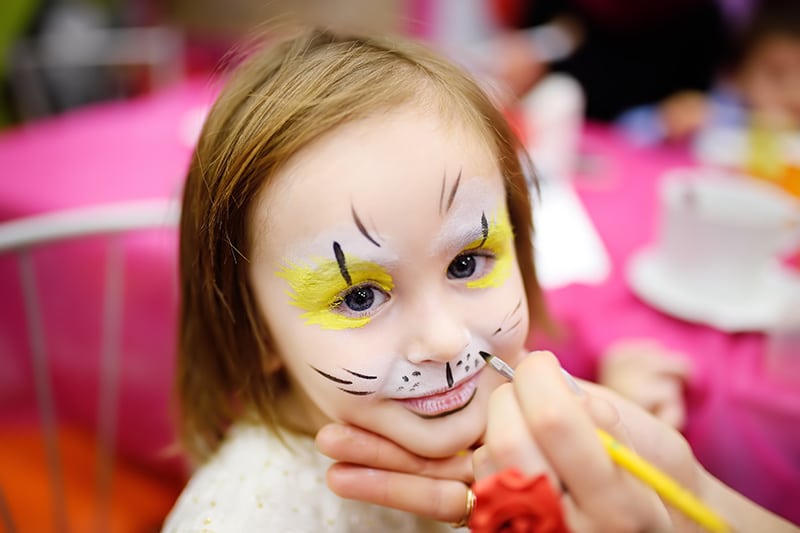 little girl getting face painting