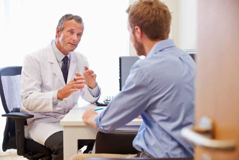 man consulting a doctor at a clinic