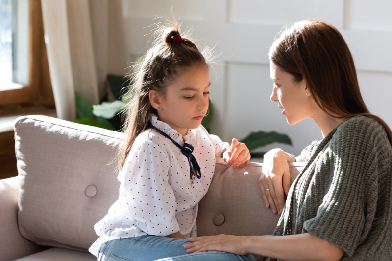 mother and child talking and sitting together on couch