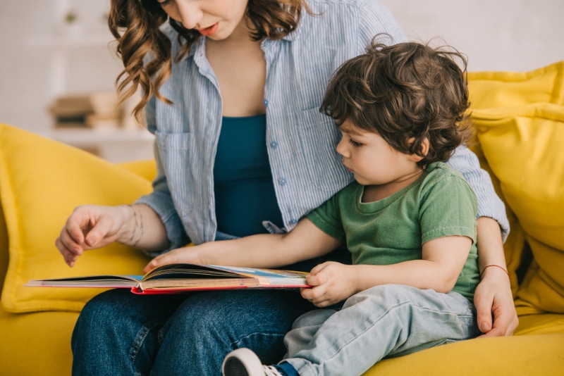 mother and son reading a book together