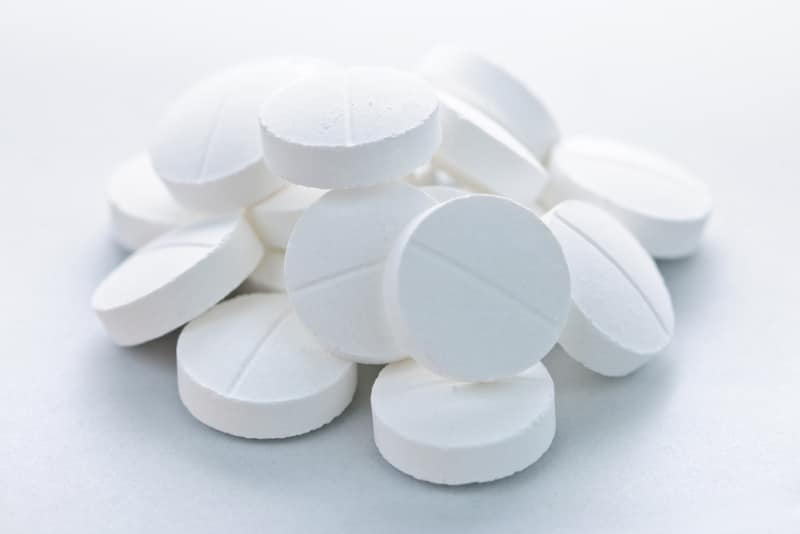 pile of white round tablets