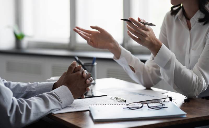 two professionals talking in a meeting