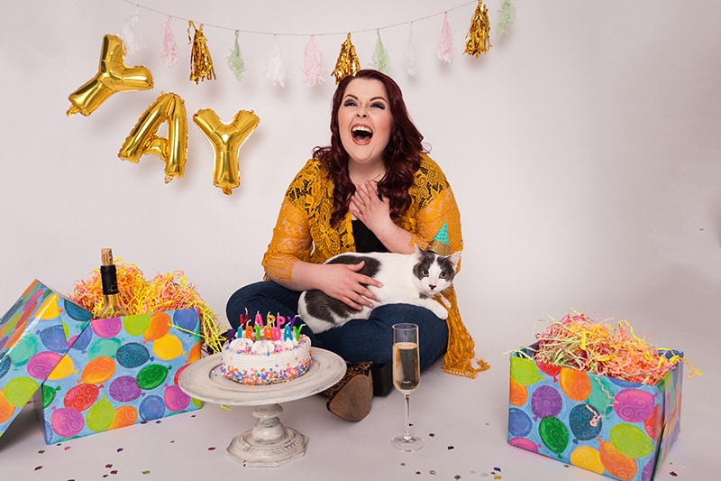 woman celebrating her birthday with her cat