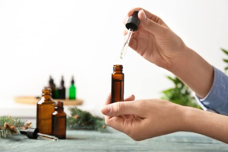 woman holding essential oil