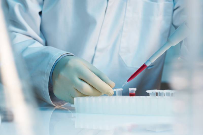 close up of scientist using pipette in laboratory