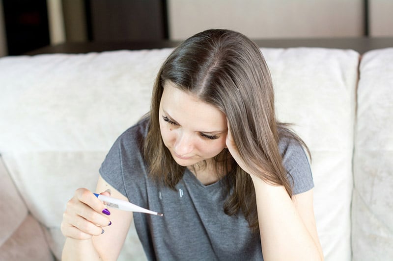 woman checking her temperature