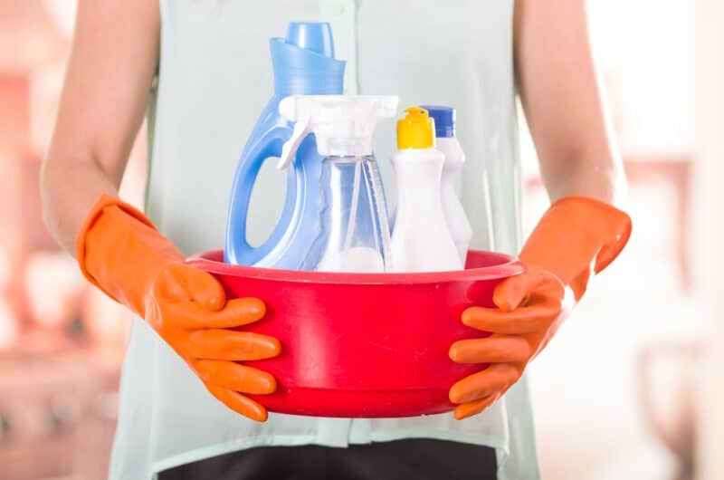 woman-holding-bucket-of-cleaning-products