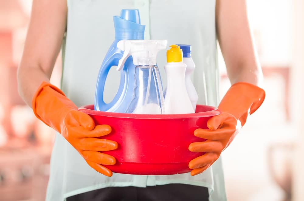 woman-holding-bucket-of-cleaning-products