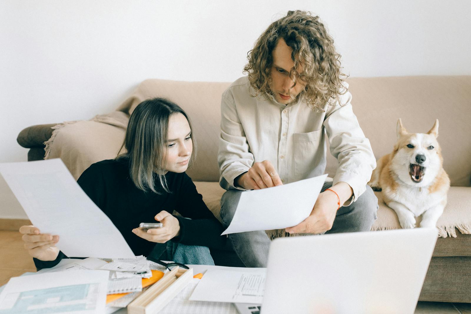 Man and Woman Holding Papers for pet insurance