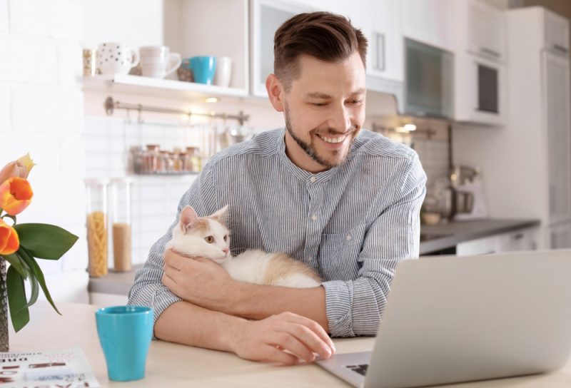 man-with-cat-using-laptop