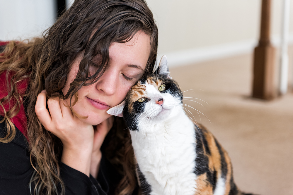 calico cat bunting on woman's head