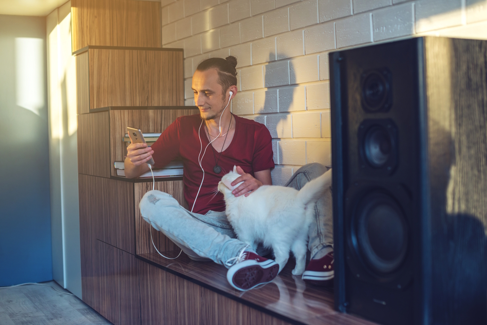 man-listening-to-music-with-his-cat