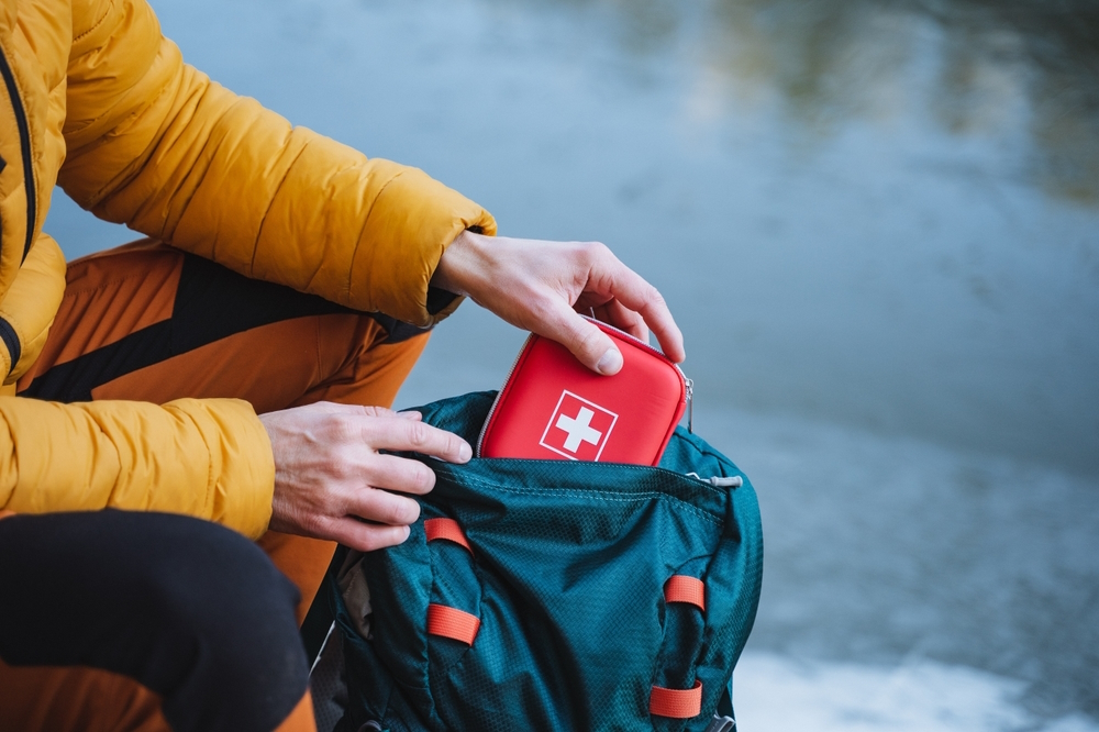 man-puts-emergency-kit-on-back-pack