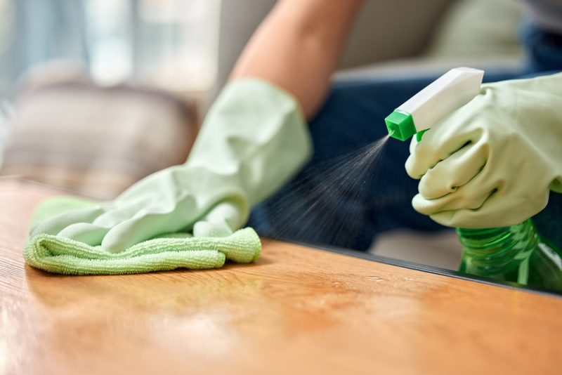 person cleaning the table